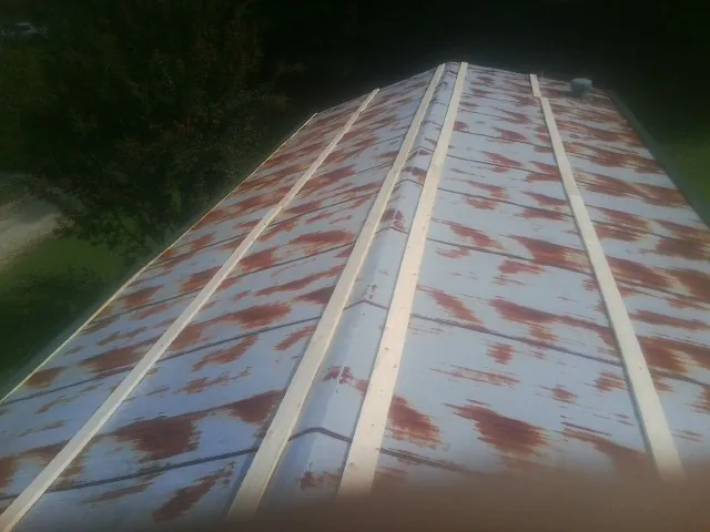 Rusted metal roof panels with new wood purlins before replacement — Storm Damage Roof Repair in Manns Choice by Roofing Brothers