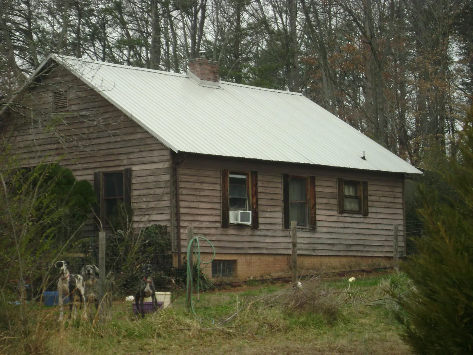 White metal roof on an old wood sided farmhouse, from a Metal Roof Installation job in Manns Choice